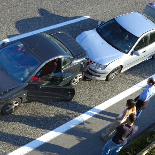 deux voitures qui sont arrêtées sur le bord de la route suite à un accrochage